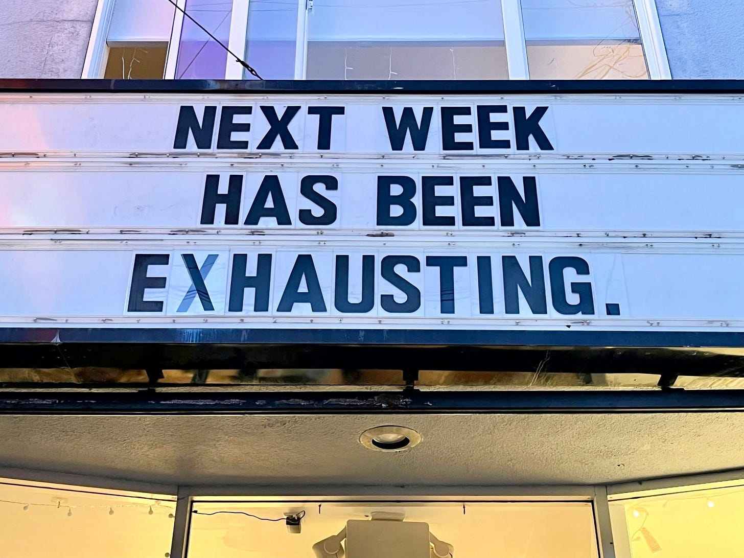 a movie theater marquee that reads, "Next week has been exhausting."