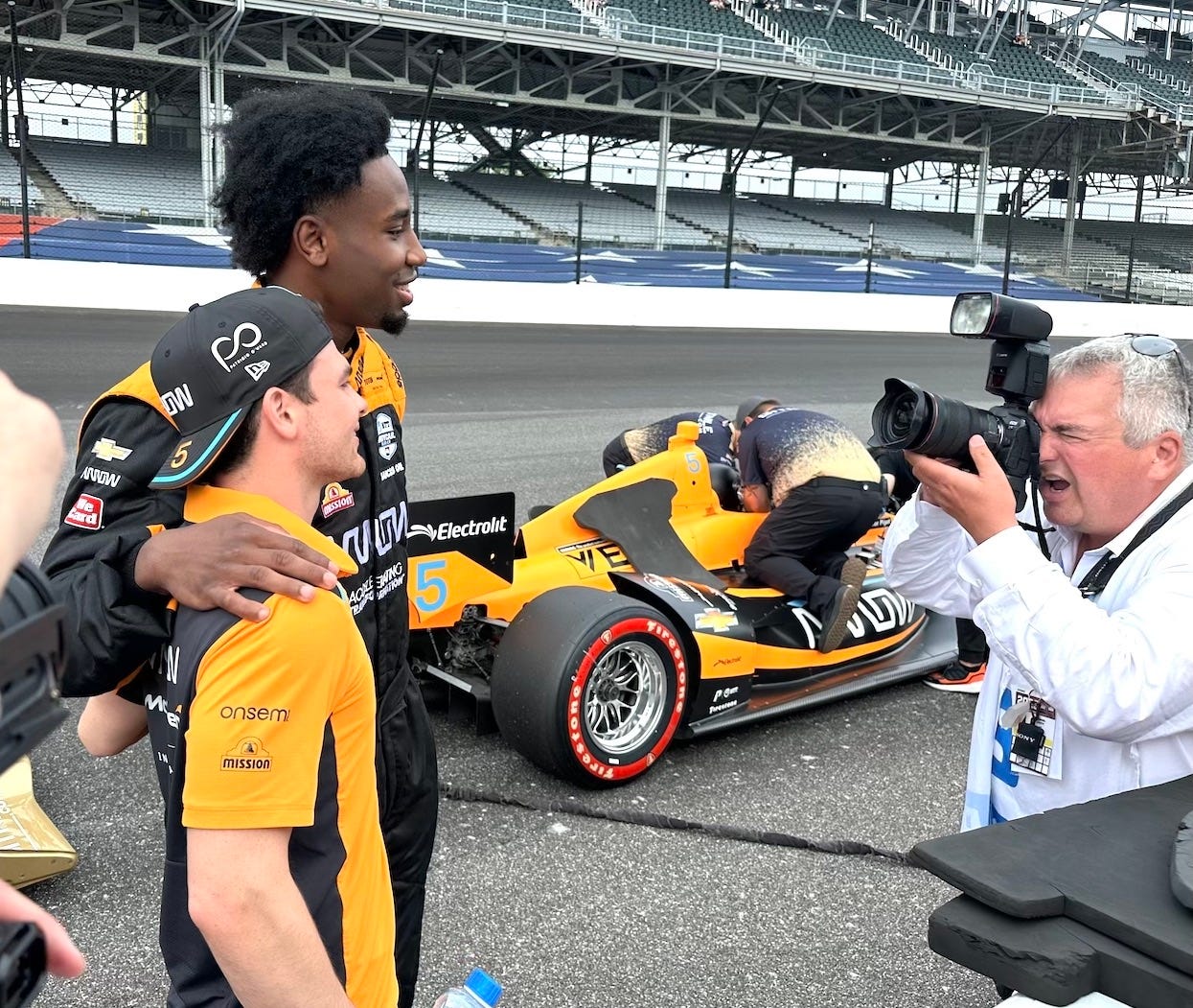 IndyCar driver Pato O'Ward poses for a photo with Aaron Nesmith of the Pacers on the track at the Indianapolis Motor Speedway Saturday morning.