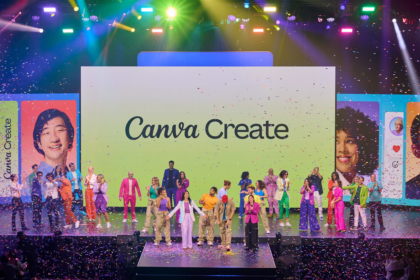 Canva cofounders Cliff Obrecht, Melanie Perkins and Cameron Adams on a large stage at Canva Create 2024 with approximately 31 Canva team members surrounding them. There is confetti falling to the ground and colorful lights in the background. A yellow screen behind them says Canva Create.