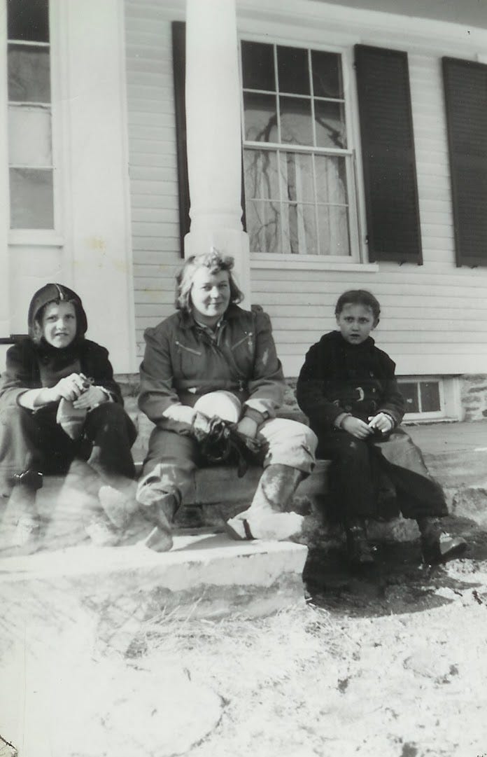 Three people seated on porch at family home