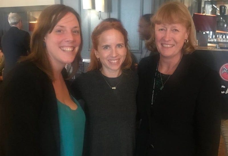 Three women pose for the camera