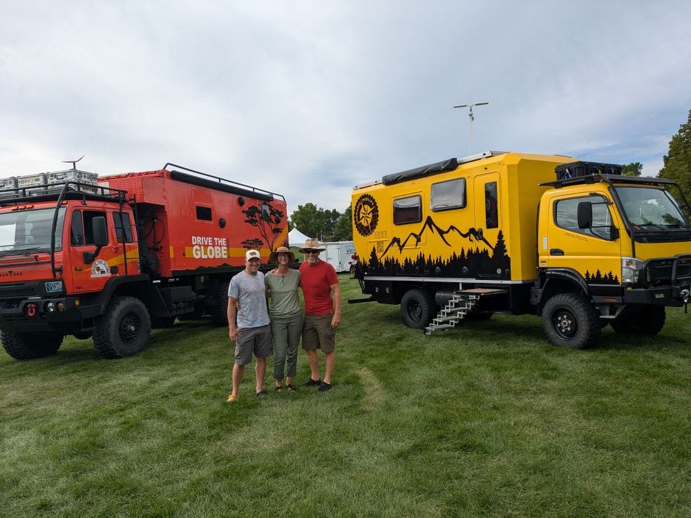 Andy and me with a new friend, posed in front of his big orange truck and our big yellow one