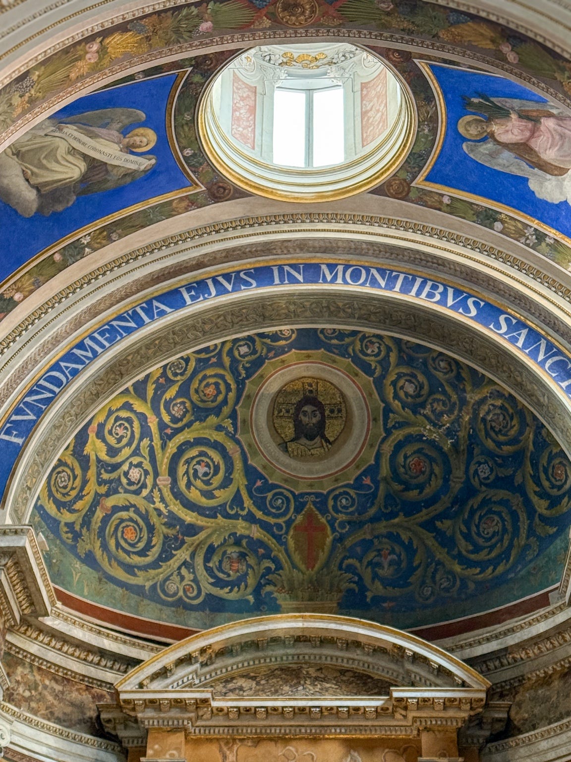 Ornate church ceiling fresco with religious artwork and Latin inscription at Santa Maria in Monticello in Rome, Italy