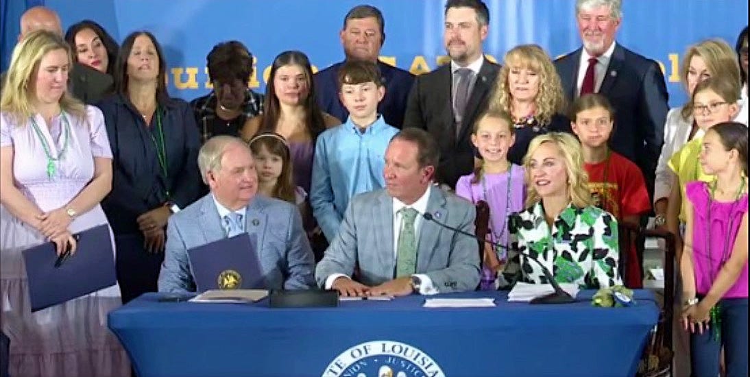 Color photo of Gov. Landry signing Louisiana's new Ten Commandments law