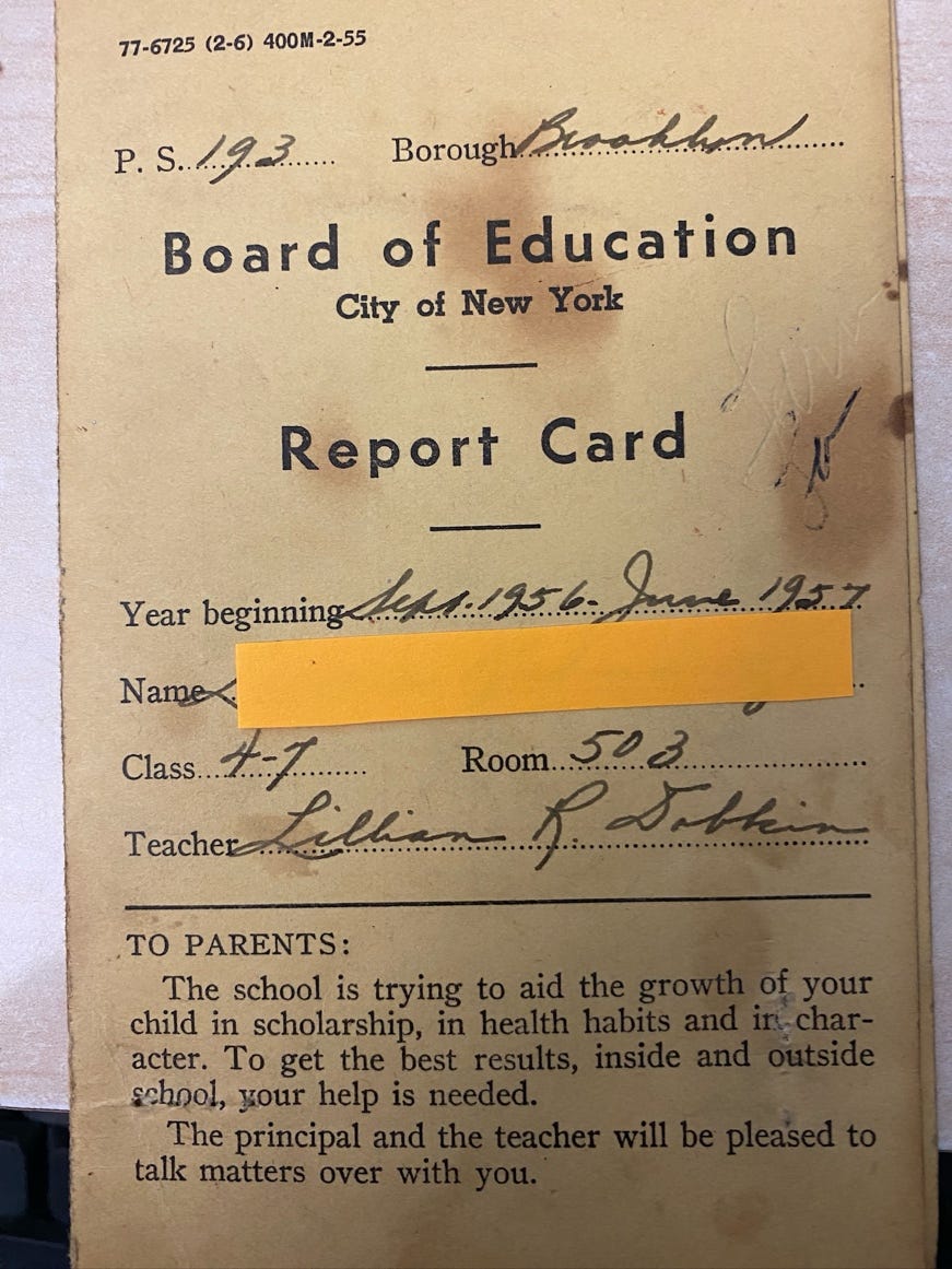 A report card with a yellow tape

Description automatically generated
