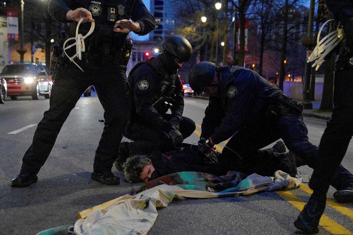 A protester is detained during Saturday's demonstrations in Atlanta. 