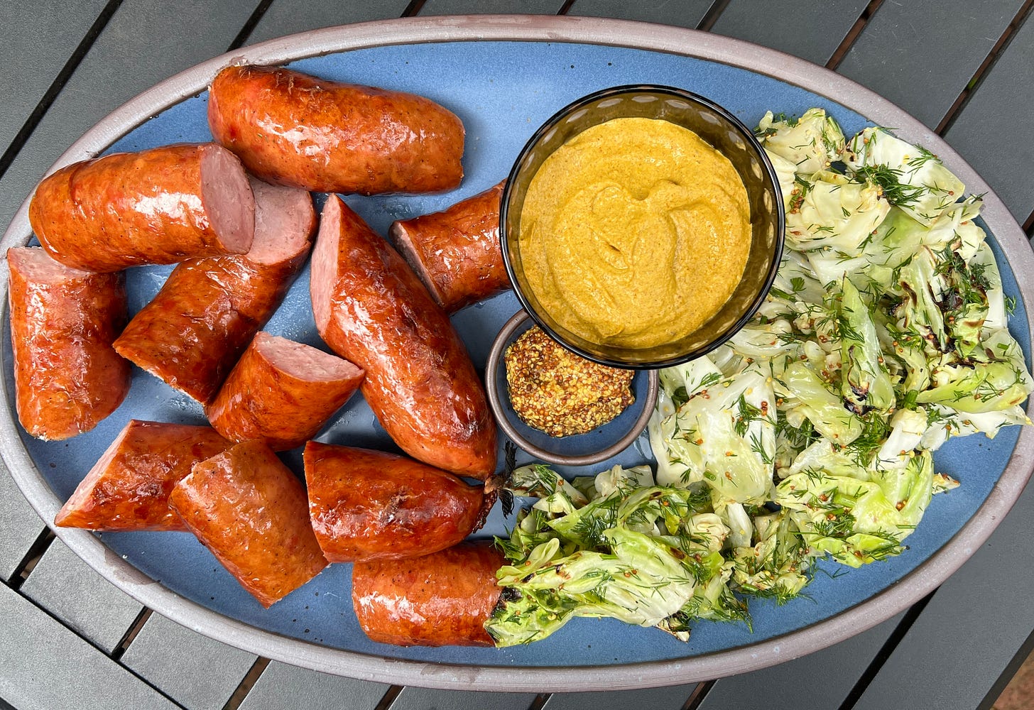 Blue platter of kielbasa and cabbage. Blue platter of kielbasa and cabbage.