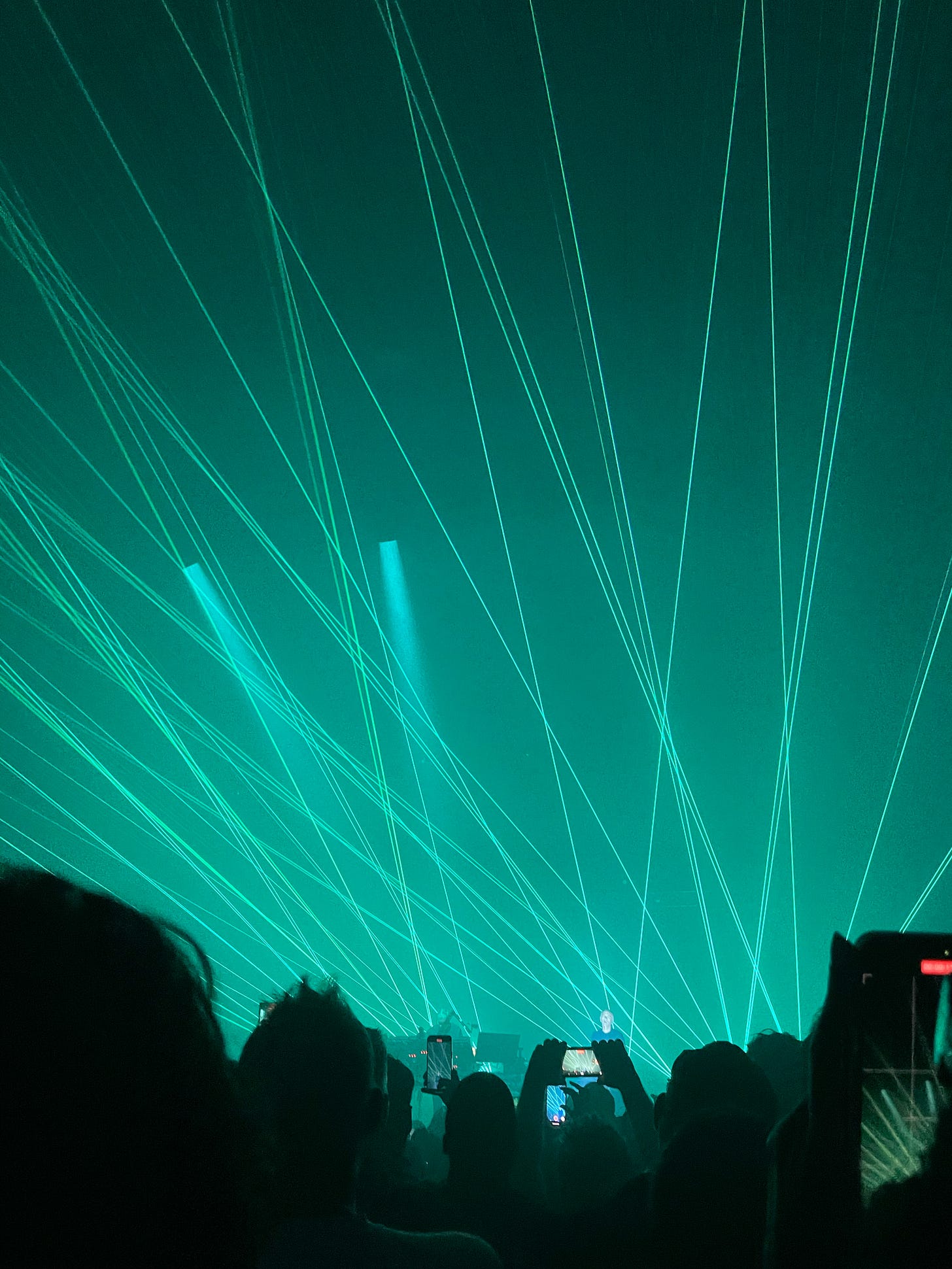 Teal lasers lighting up a concert.