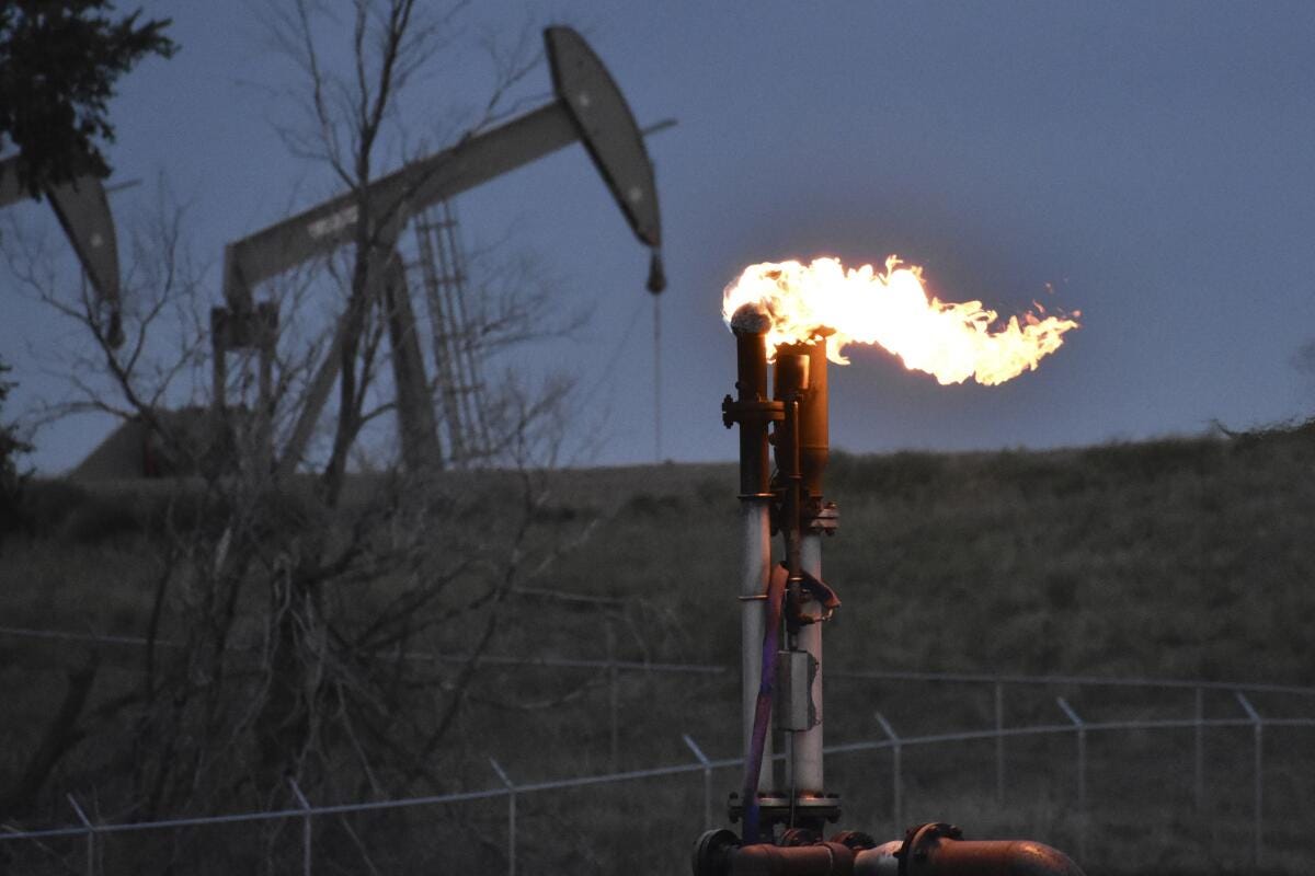 A flare burns at a gas well. 