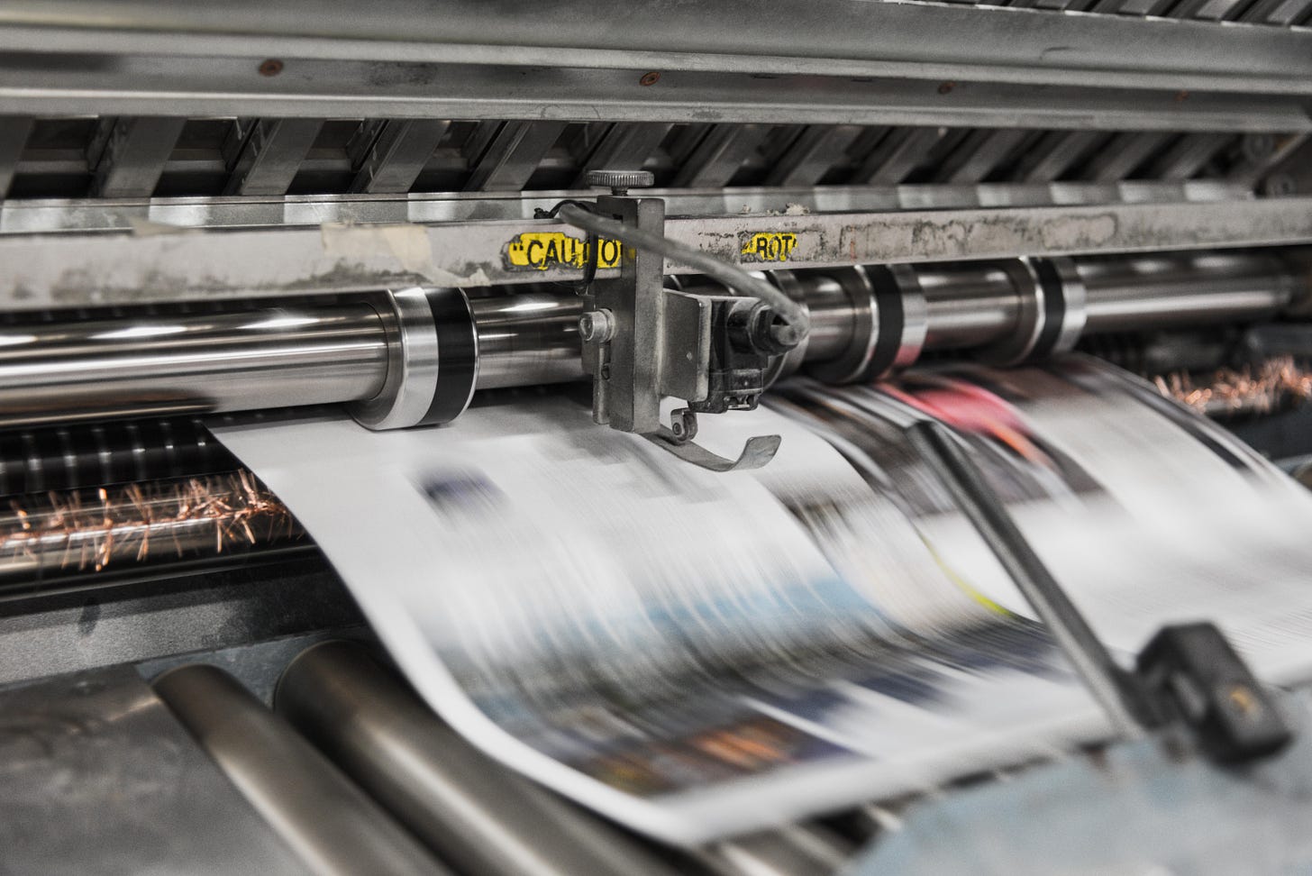 A newspaper comes off a printing press.