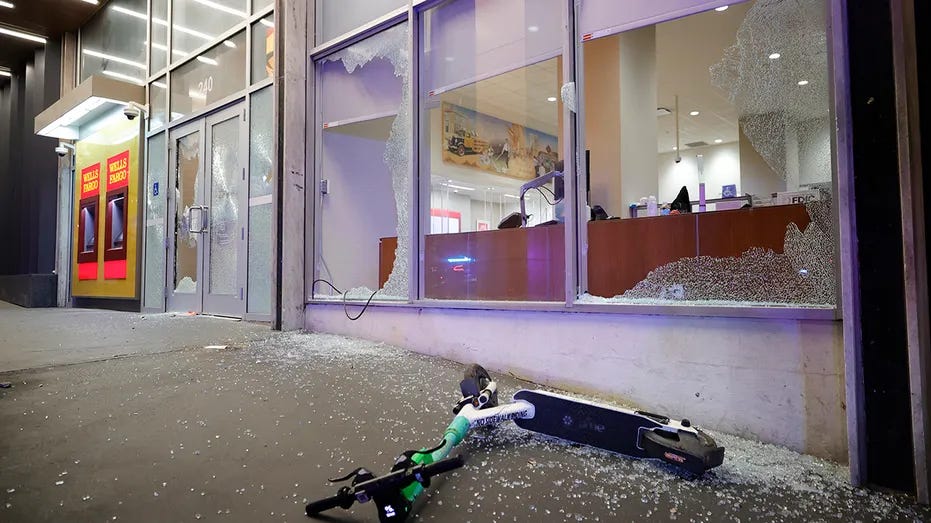 Broken windows at a Wells Fargo branch are seen following a violent protest, late Saturday, Jan. 21, 2023, in Atlanta, in the wake of the death of an environmental activist killed after authorities said the 26-year-old shot a state trooper. 