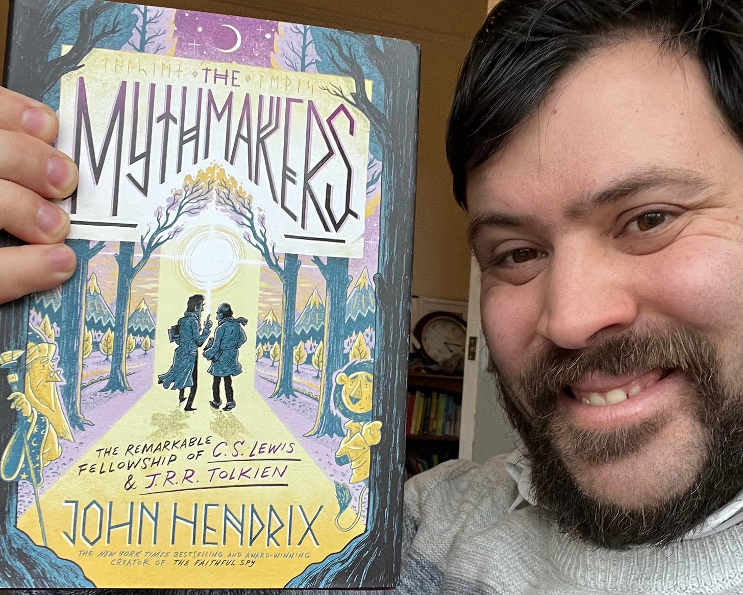 Me holding up The Mythmakers by John Hendrix, a graphic novel about Lewis and Tolkien's friendship.