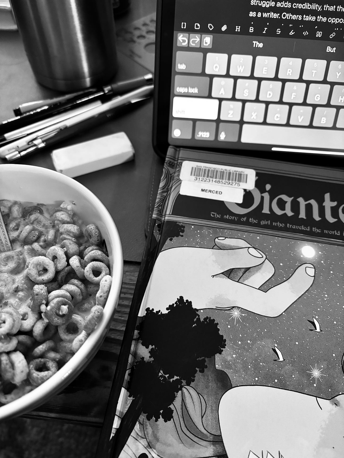 A bowl of cereal, a book, and an ipad