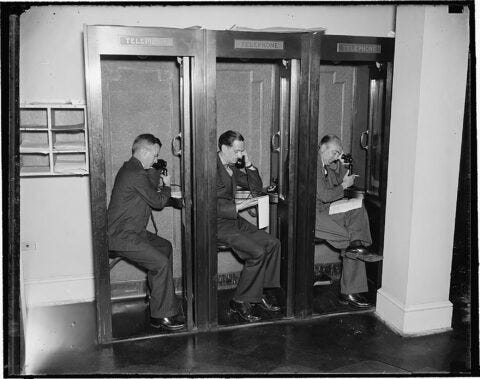 Reporters using telephones in White House press room Reporters using telephones in White House press room