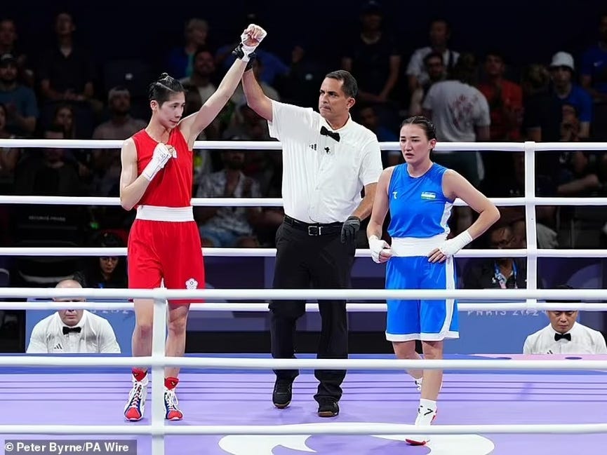 Lin Yu-Ting, towering over Uzbekistan's Sitora Turdibekova with the referee raising Yu-Ting's hand in victory, symbolizes the profound injustice and extreme dangers female athletes face when competing against male opponents under questionable (insane) eligibility.