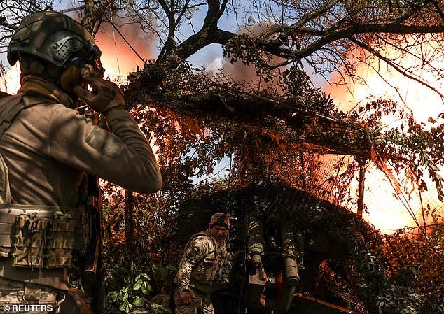 Ukrainian servicemen fire a D-20 howitzer towards Russian troops at a position near the front line town of Bakhmut. Sholz is in town to bolster support for a new U.S. aid package for Ukraine