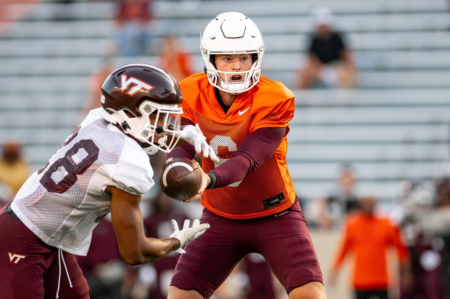 Virginia Tech quarterback Grant Wells hands off to running back Chance Black.