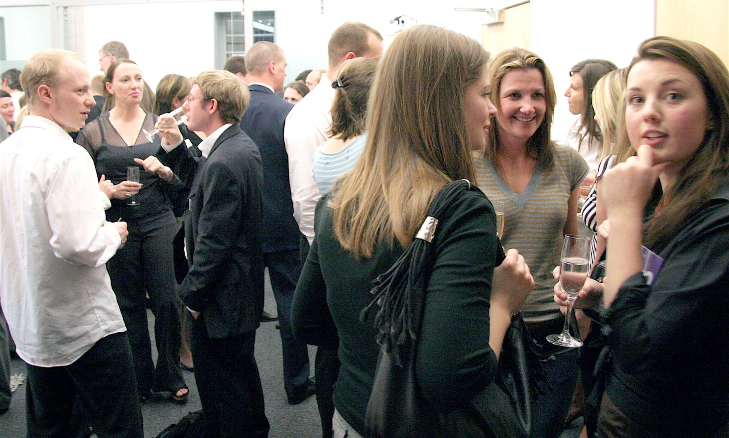 A photo of people celebrating at a launch party from Nile's past, where everyone looks significantly younger than they are now.