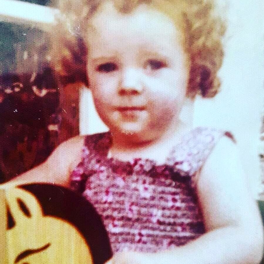 A young girl with red curly hair