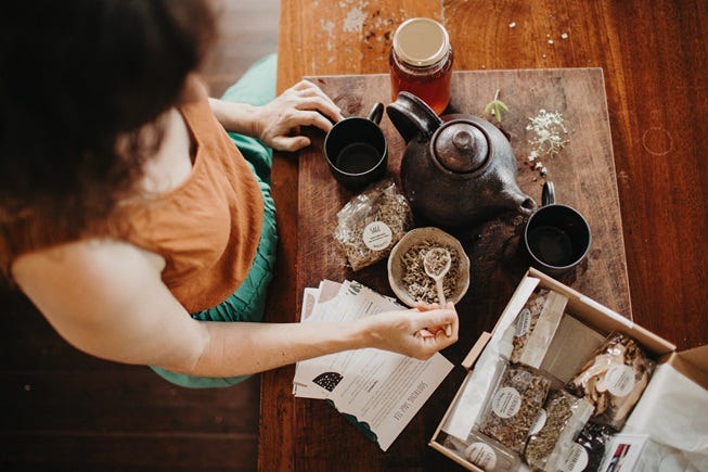 Image of Cat Green and make a herbal remedy using Sage, one of the herbs in the DIY Immunity Remedy Kit. Image shot from above. Herbal medicine education made simple and fun for family herbalists and home herbalists. Everyday Empowered