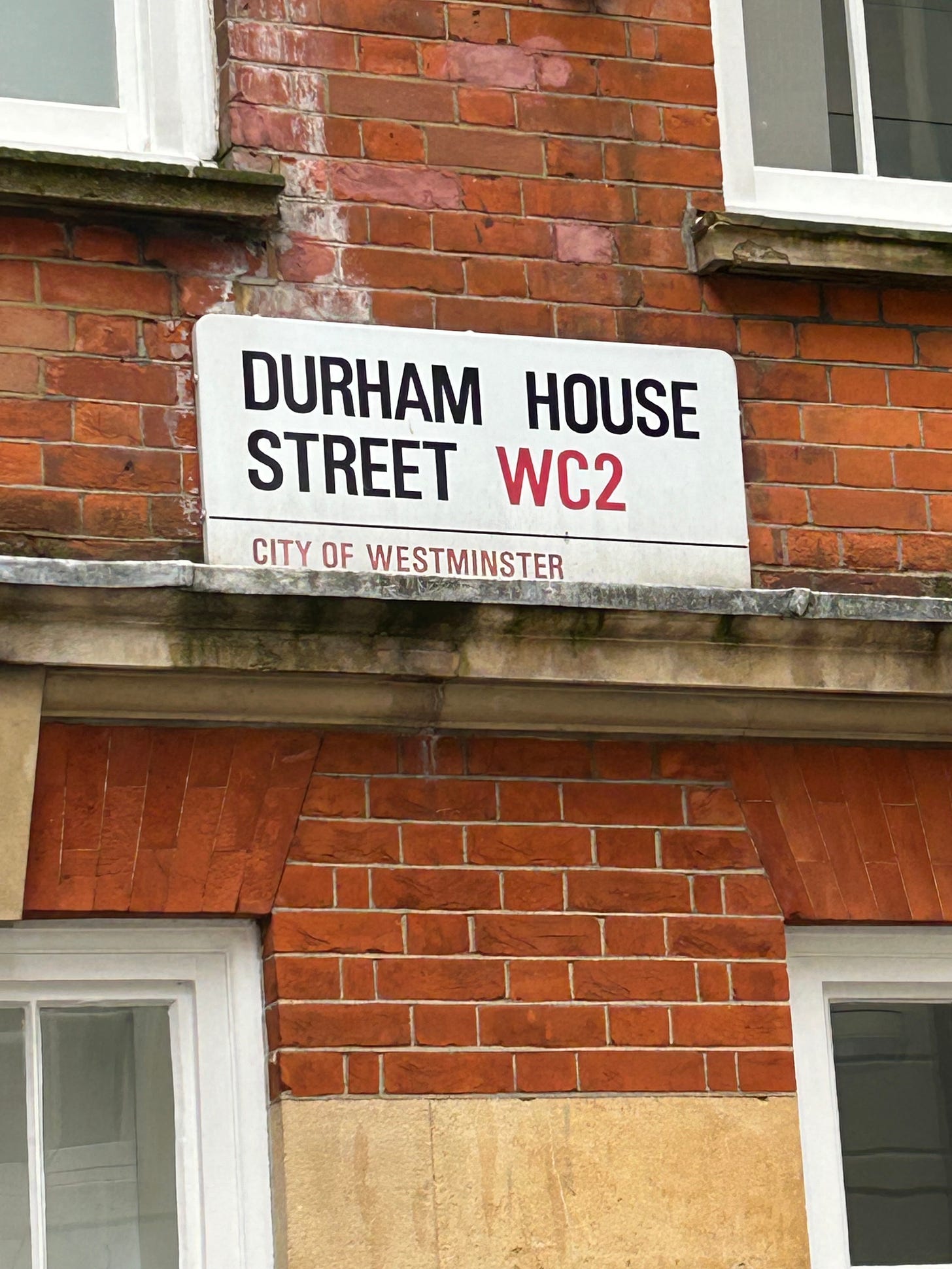 A red brick building, with a street name of Durham House Street, WC2