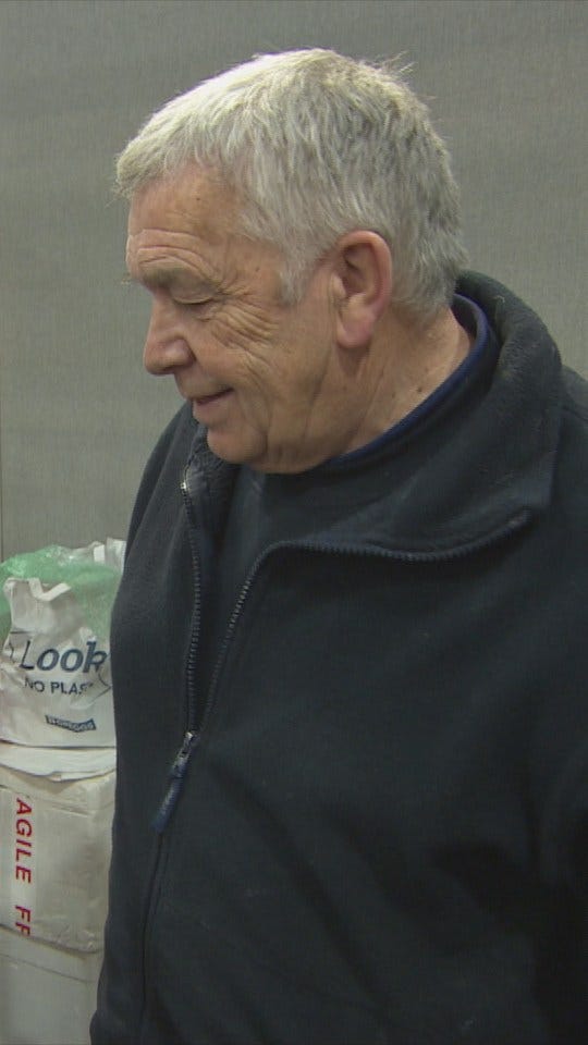 A man in a dark zip-up jacket.