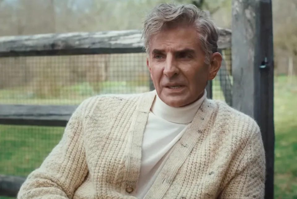 Bradley Cooper as Leonard Bernstein in a turtleneck and cable knit cardigan