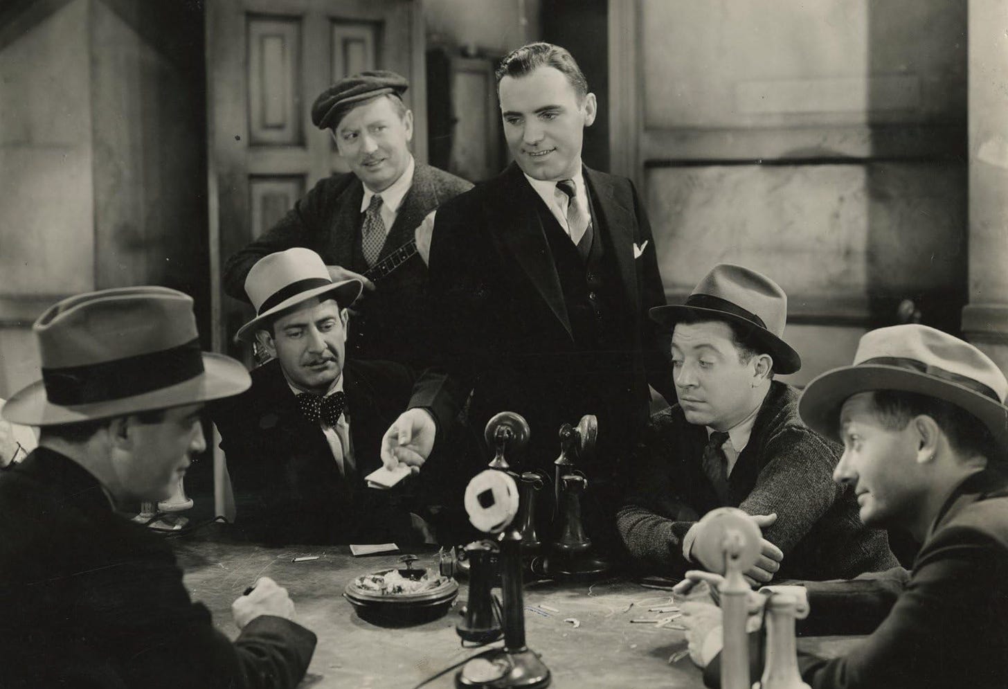 (L-R) Fred Howard, Eugene Strong, Matt Moore, Pat O’Brien, Frank McHugh, and Phil Tead in a scene from The Front Page