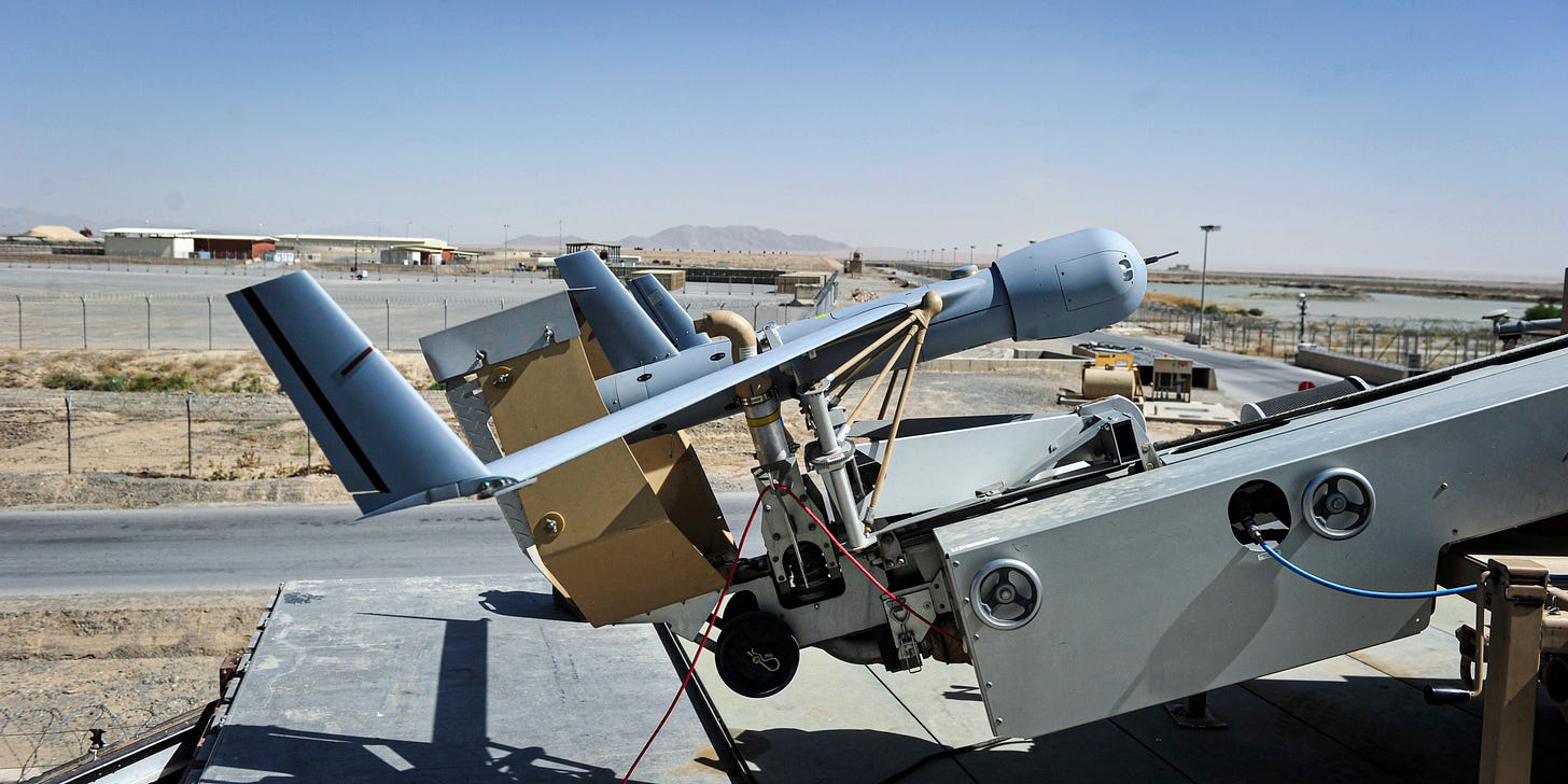 150625-N-SQ656-452 KANDAHAR AIRFIELD, Afghanistan (June 25, 2015) A ScanEagle unmanned aerial vehicle from ScanEagle Guardian Eight Site sits ready for launch by Rear Adm. Luke McCollum, vice commander, U.S. Naval Forces Central Command. McCollum met with deployed Sailors in his area of responsibility assigned to Train, Advise and Assist Command - South based at Kandahar Airfield. ScanEagle missions include intelligence, surveillance and reconnaissance for the NATO-led Resolute Support effort. (U.S. Navy photo by Lt. Kristine Volk, Resolute Support Public Affairs/Released)