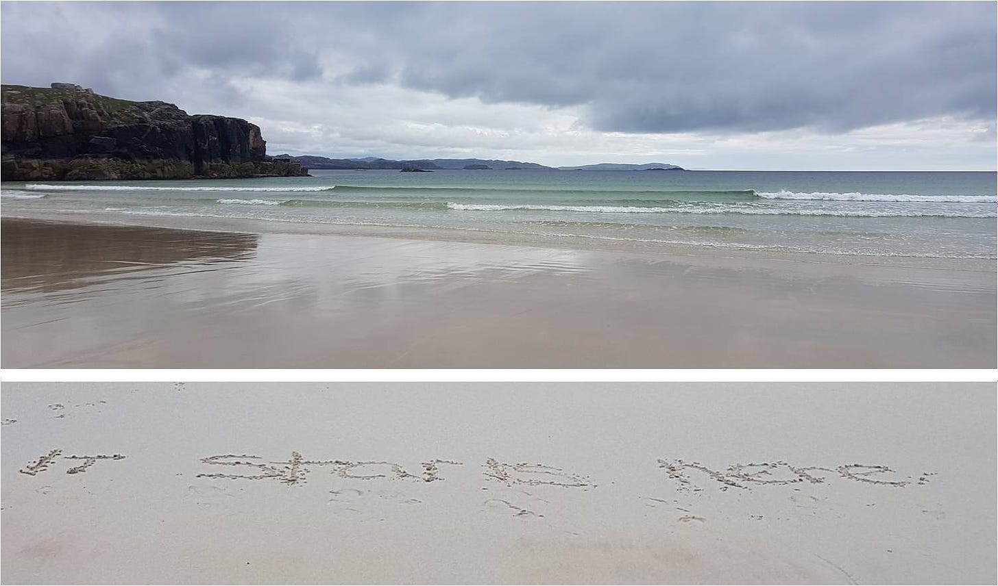 Remote beach in Scotland under moody skies, with "It starts here" written on the sand.