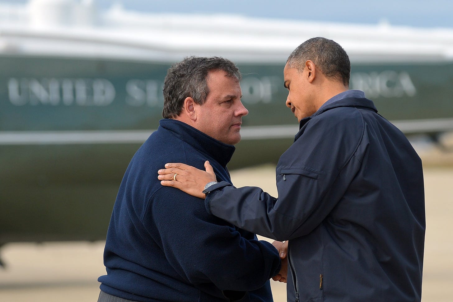 President Barack Obama is greeted by New Jersey Governor Chris Christie upon arriving in Atlantic City, New Jersey, on Oct. 31, 2012 to visit areas hardest hit by the unprecedented cyclone Sandy.