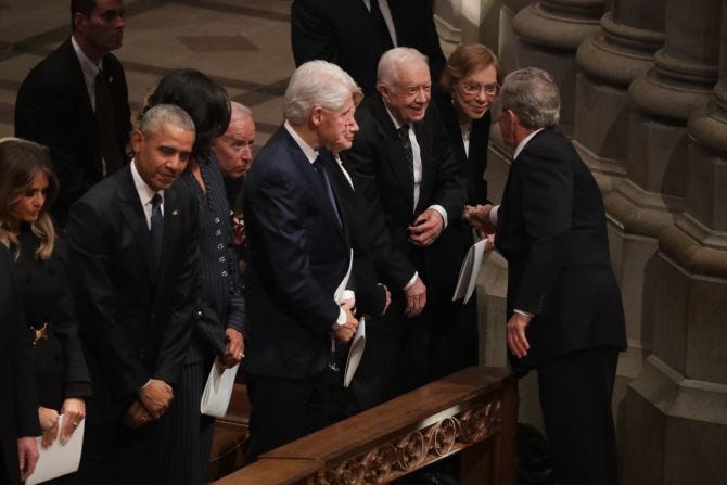 Former US President George W. Bush greets Carter and other former presidents during the state funeral for his father in December 2018.