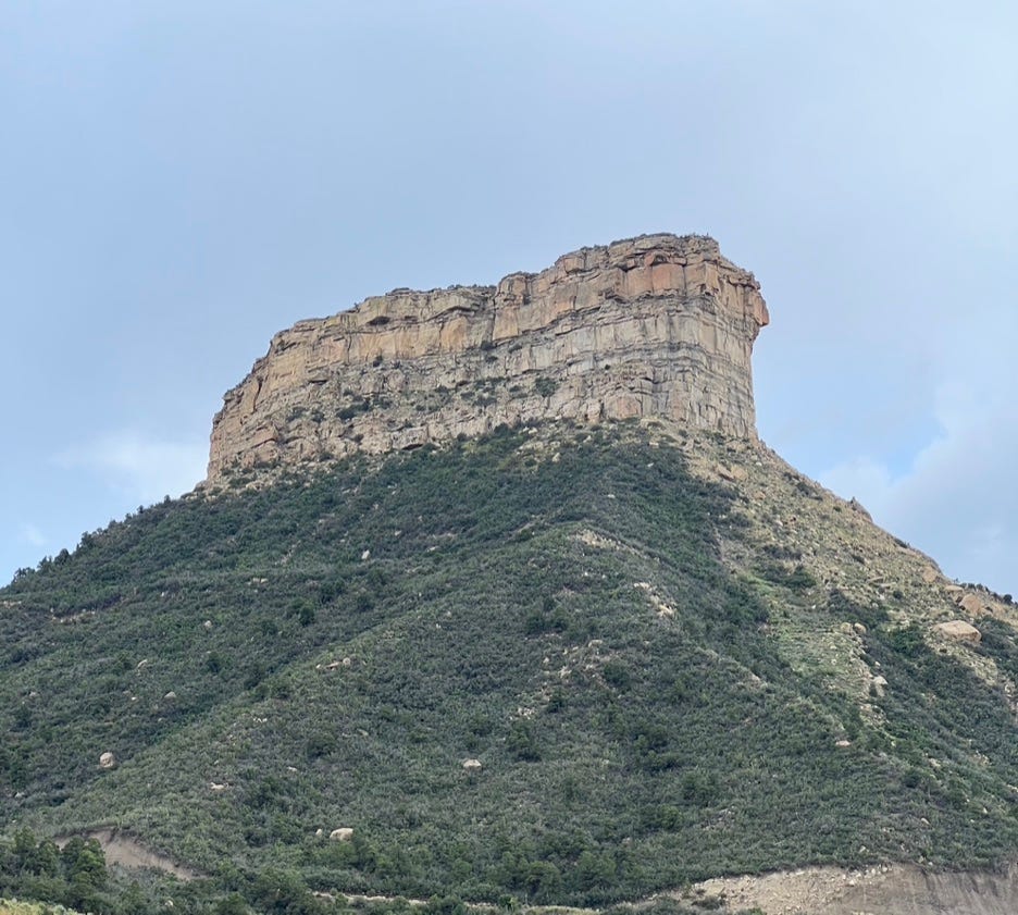A large rock formation on a mountain

Description automatically generated