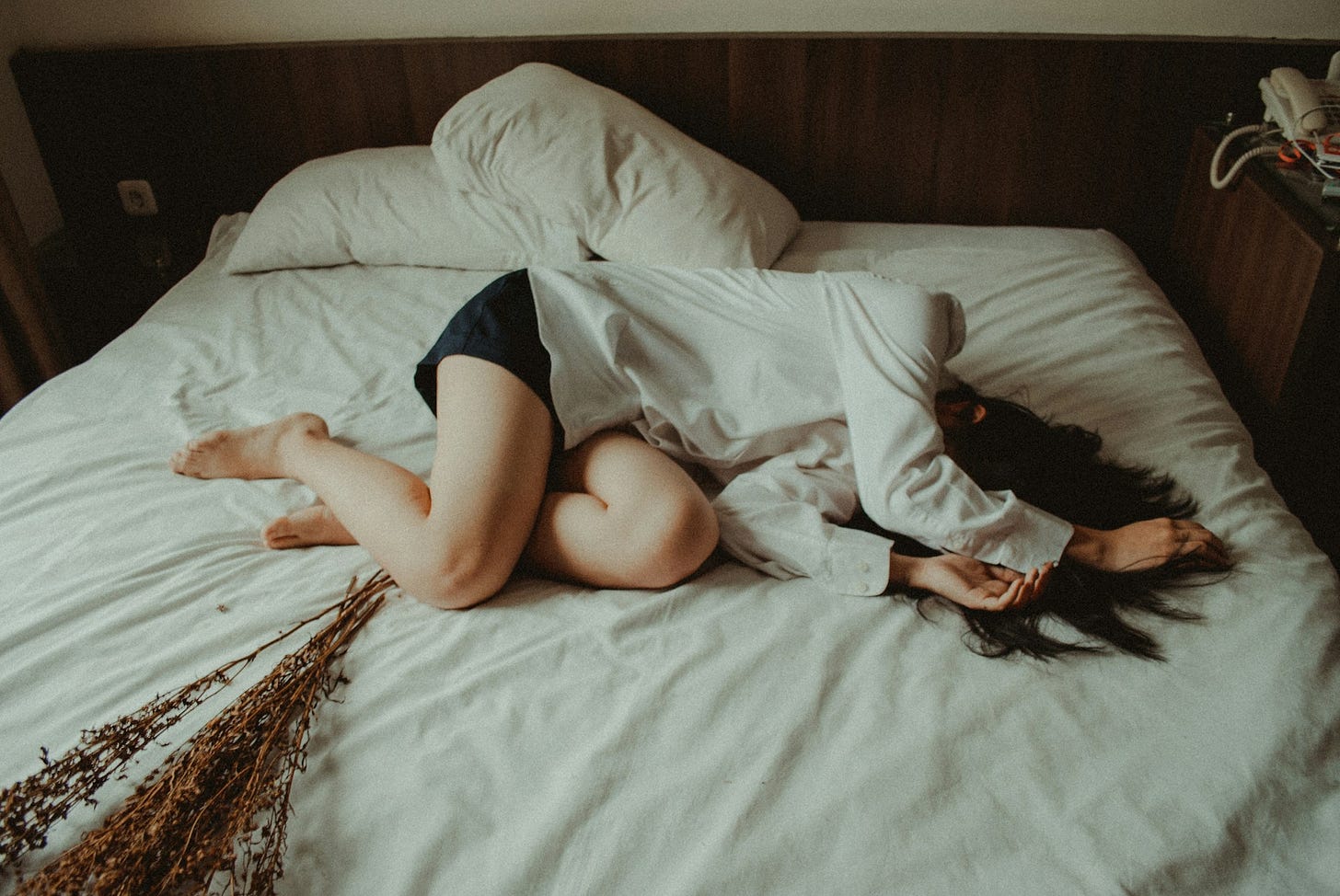 Depressed woman lying in bed