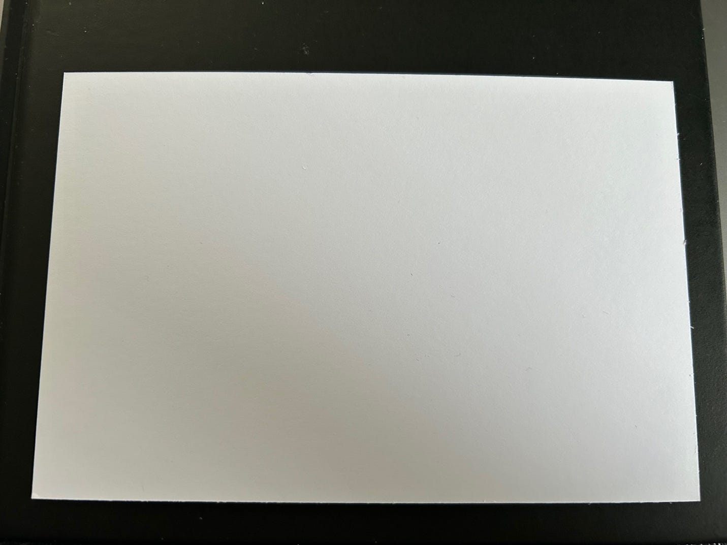 A white rectangular object on a black surface

Description automatically generated