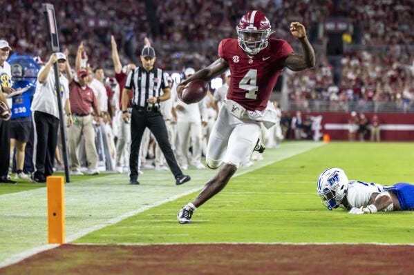 Alabama quarterback Jalen Milroe (4) runs the ball in for a touchdown against Middle Tennessee during the first half an NCAA college football game Saturday, Sept. 2, 2023, in Tuscaloosa, Ala. (AP Photo/Vasha Hunt)