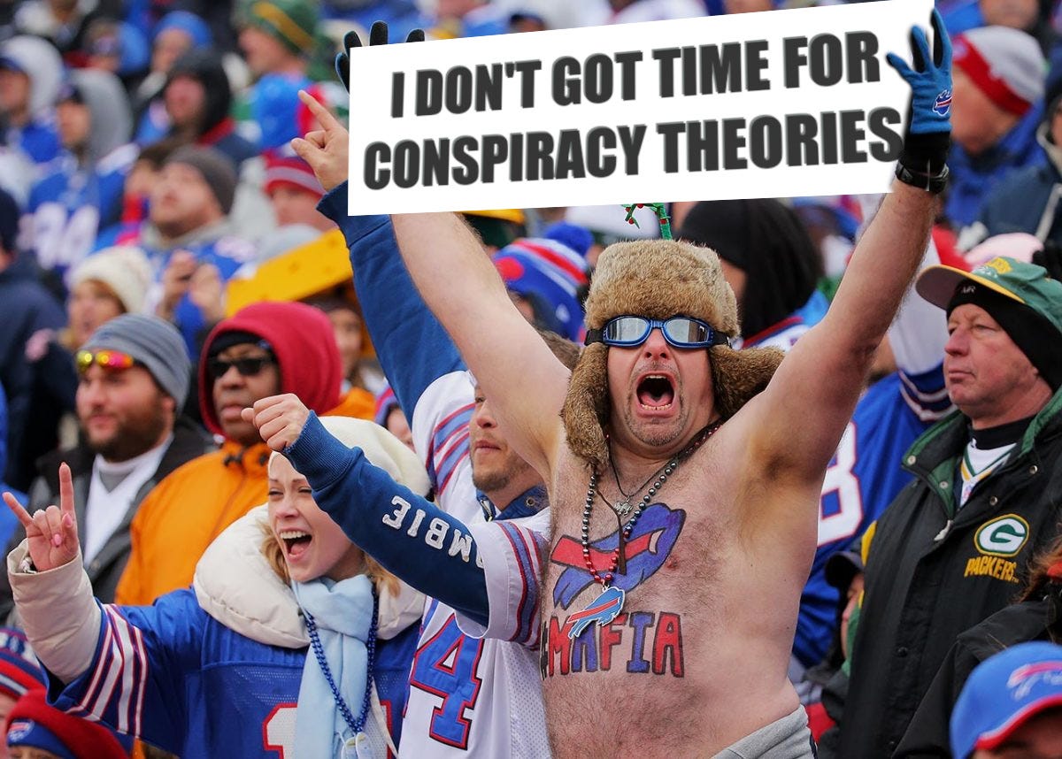 Shirtless NFL fan holding sign: I don't got time for conspiracy theories