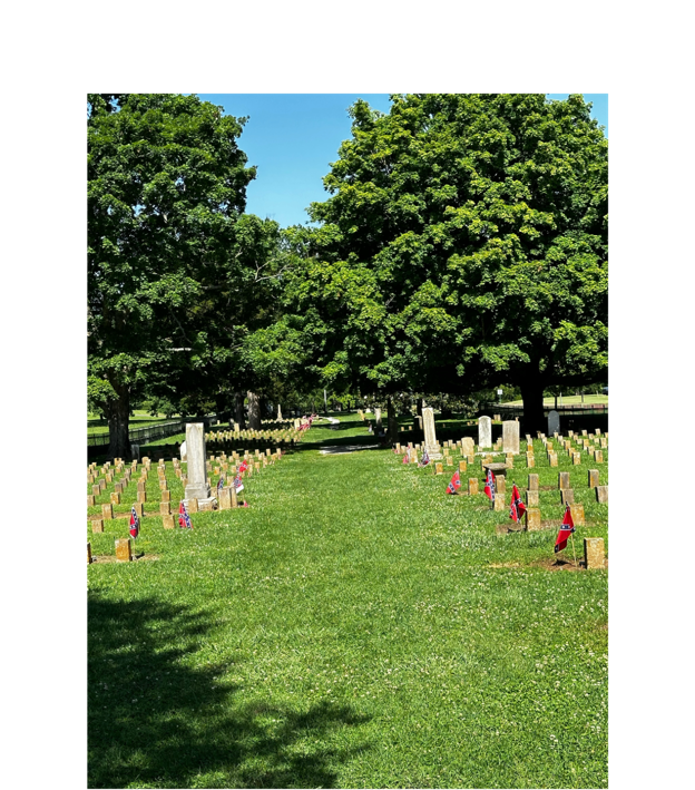 A group of people in a cemetery

Description automatically generated