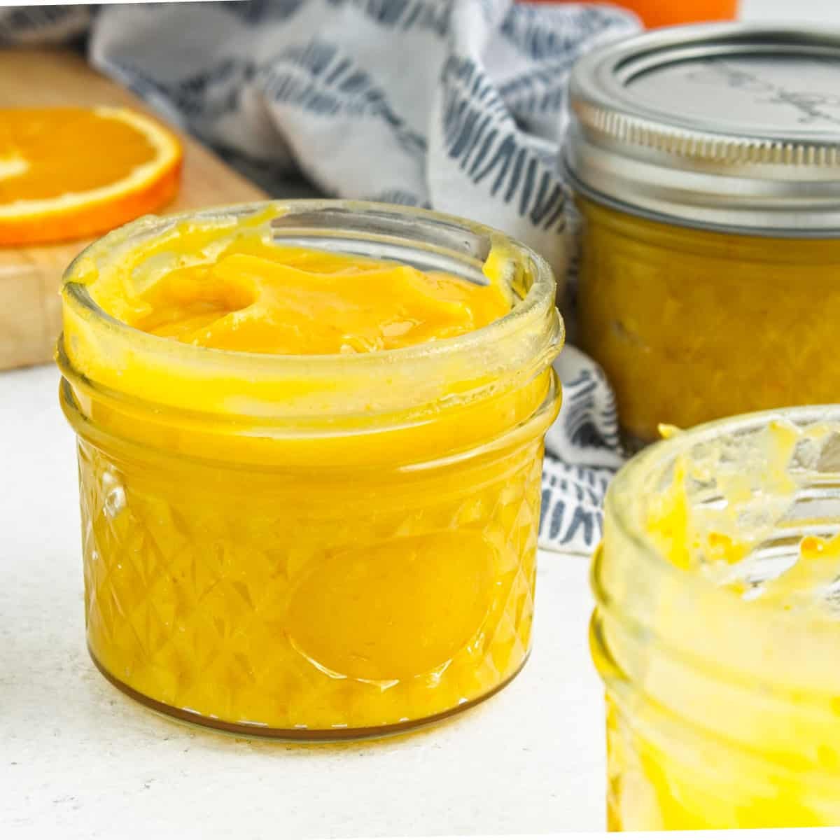 Orange curd in mason jars.