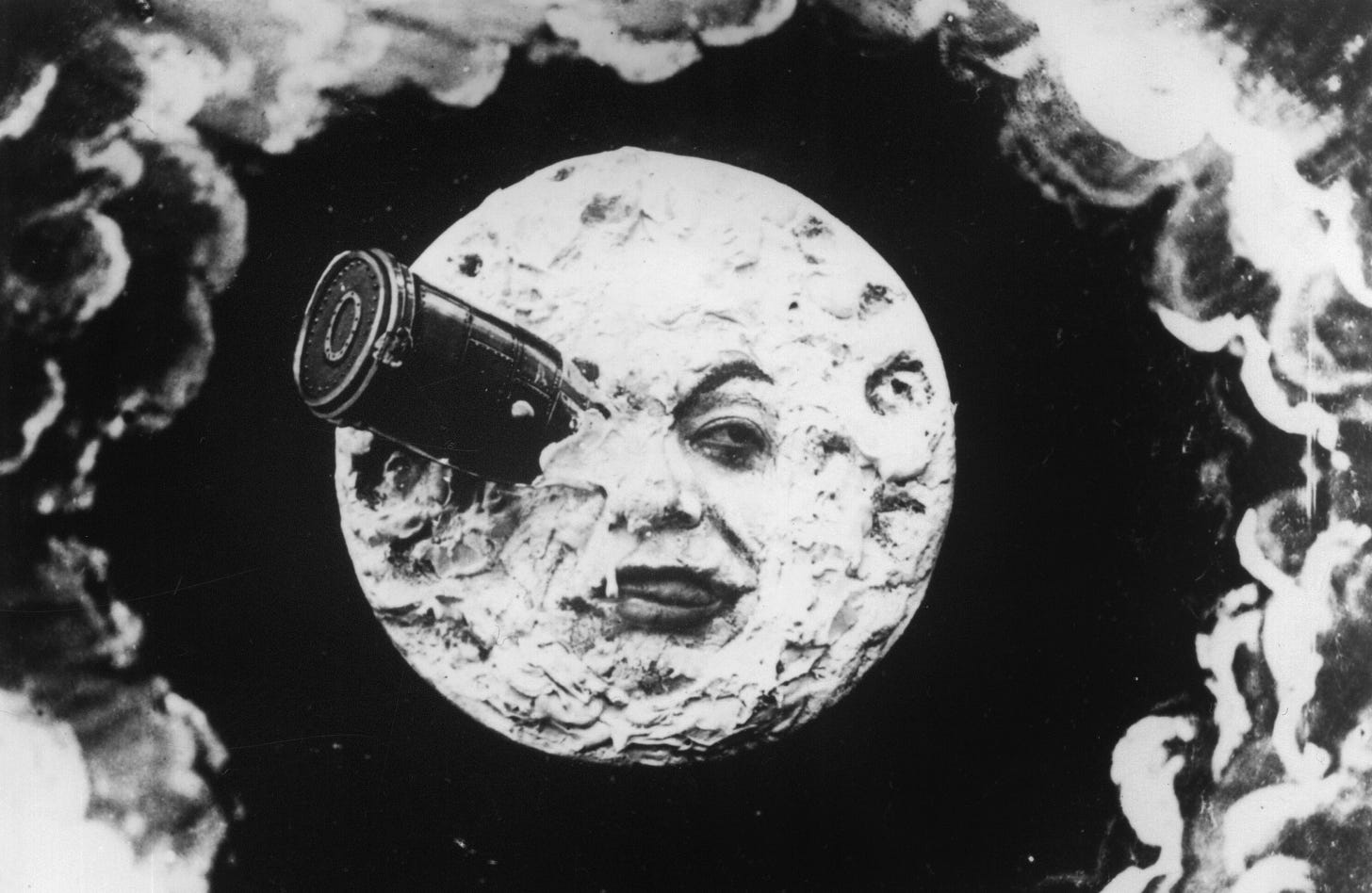 still from a trip to the moon, a moon with a human face and a can in its eye