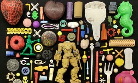 Colourful plastic objects found by a beachcomber laid out as if they were in a display case in a museum