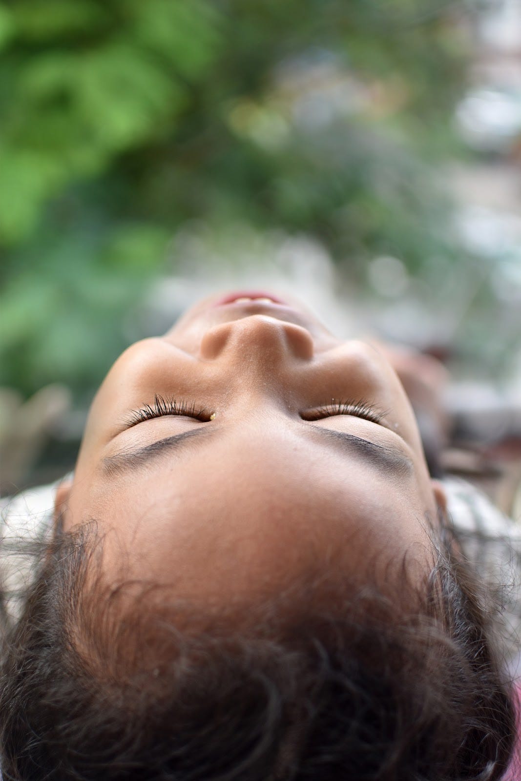 A young boy lies on his back and smiles