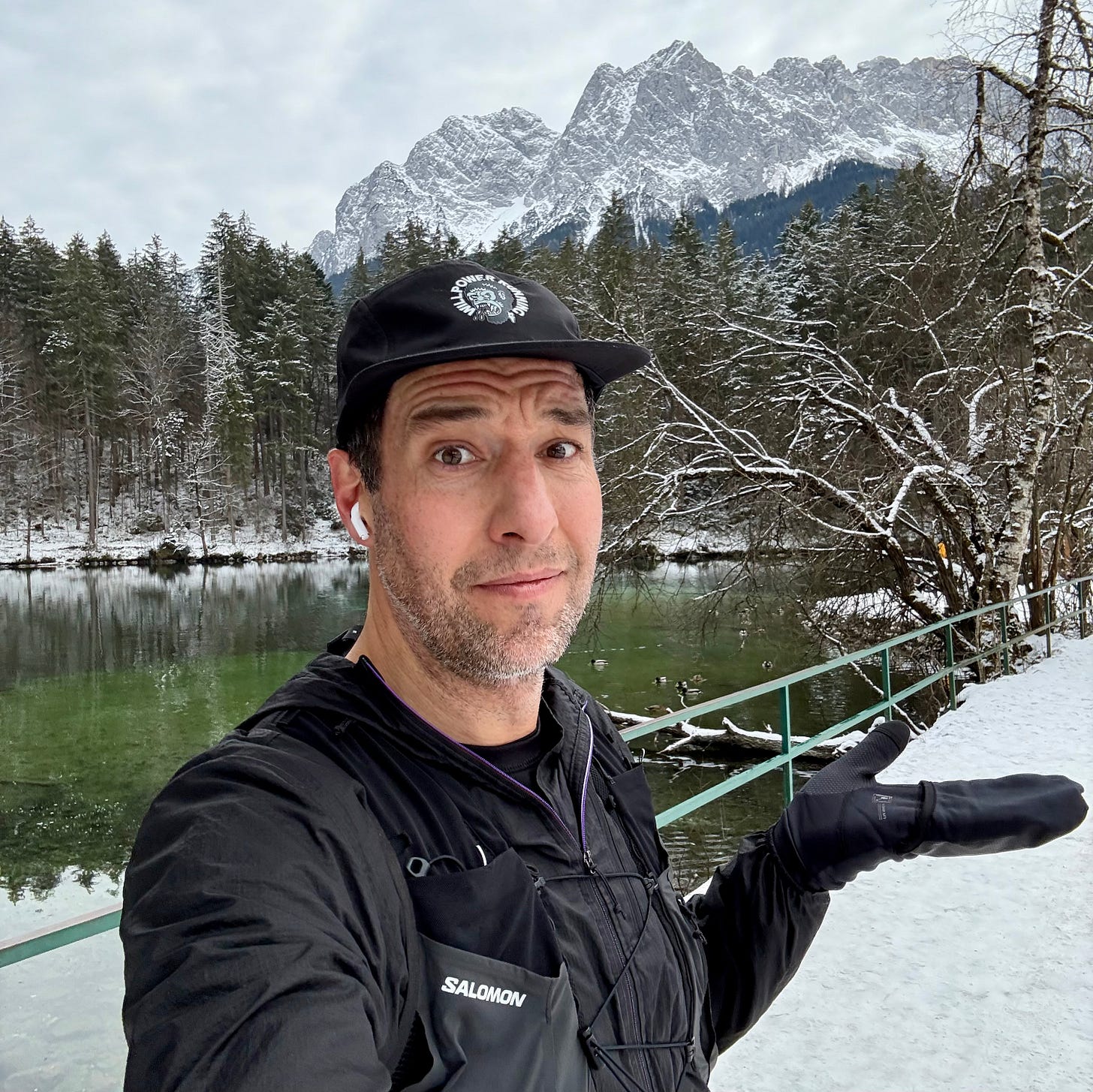 The author in front of a mountain range covered in snow