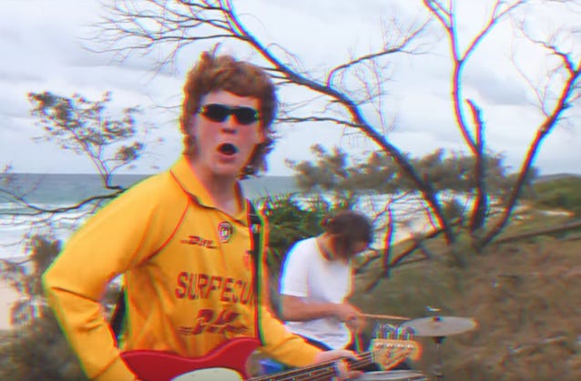 A person playing guitar with his mouth open

Description automatically generated