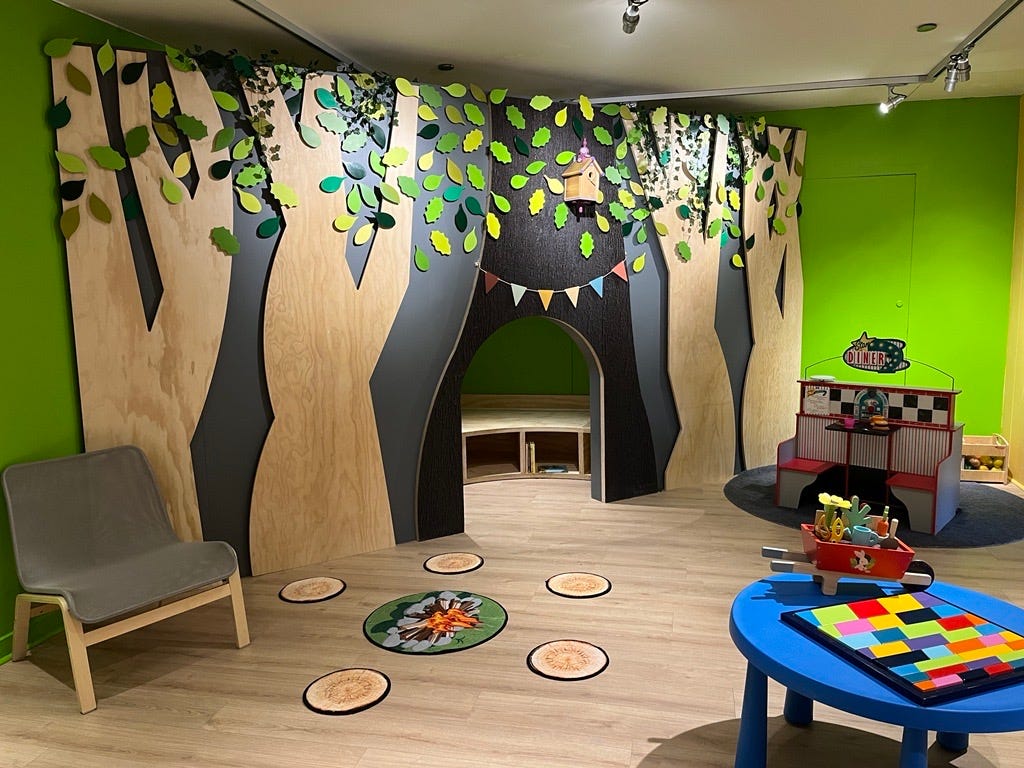 Discovery Space play room with lots of natural materials and colourful toys.