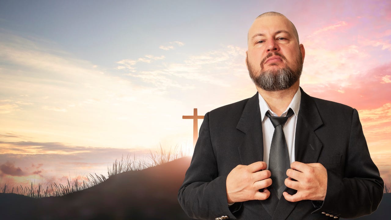 A arrogant man wearing a suit standing in front of the cross.