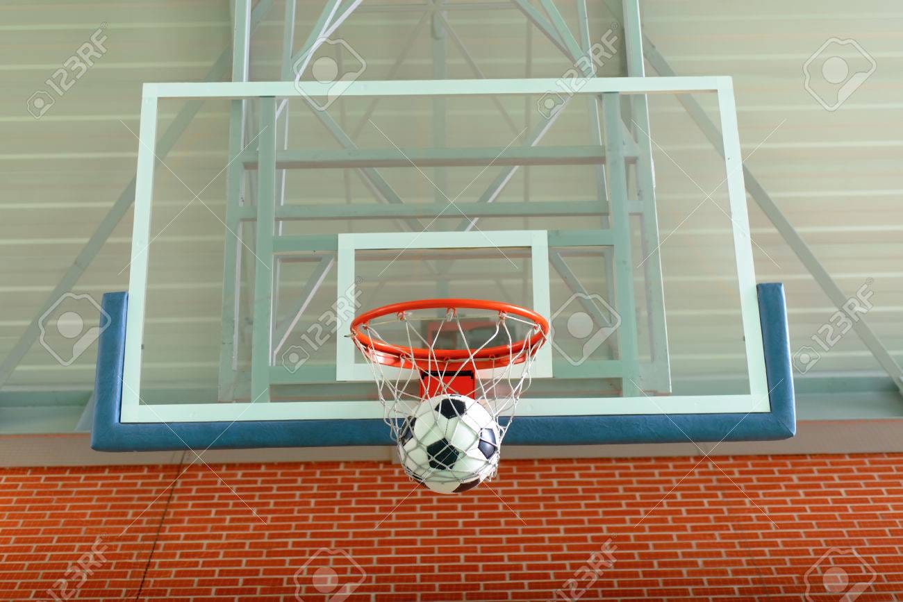 Soccer Ball Passing Through A Basketball Hoop And Net To Score A Goal On An  Indoor Court Stock Photo, Picture And Royalty Free Image. Image 56119328.