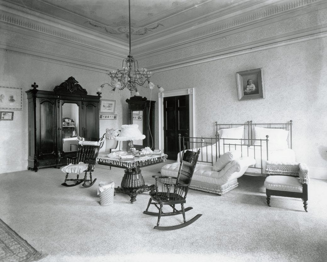 A photo of a room at the Whitehouse around 1899. A gas-powered light fixture has been adapted to use electricity.