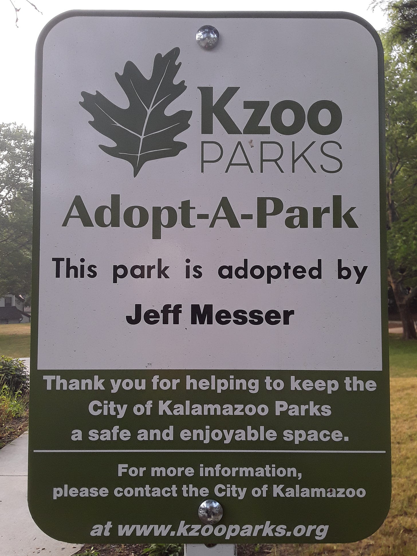 Photograph of the Kzoo Parks Adopt-A-Park sign in Davis Street Park on Wednesday, ‎June ‎28.  It reads:  "This park is adopted by Jeff Messer".