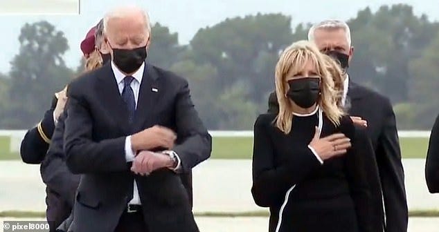 Biden appeared to check his watch moments after a salute for the bodies of 13 US service members killed in the Kabul blast. He and the first lady made an unannounced trip to Dover Air Force Base to formally receive the fallen troops